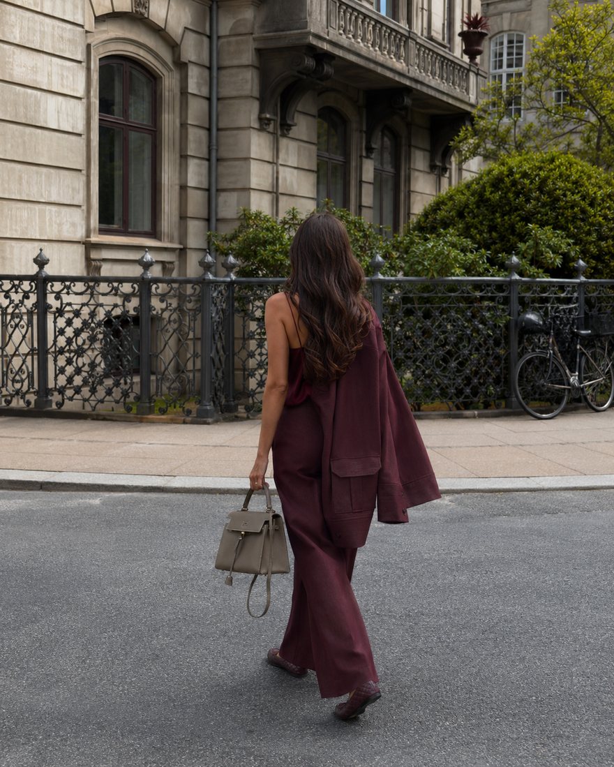 AI-generated fashion editorial — model in a burgundy suit on a Parisian street